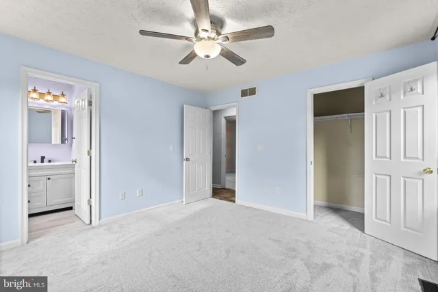 a view of a hallway with a bathroom