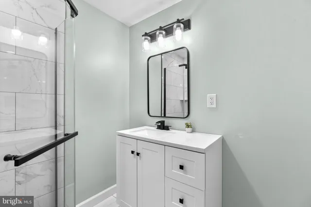 a bathroom with a sink vanity and a mirror