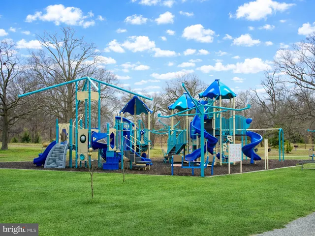 a view of a tennis ground with large trees