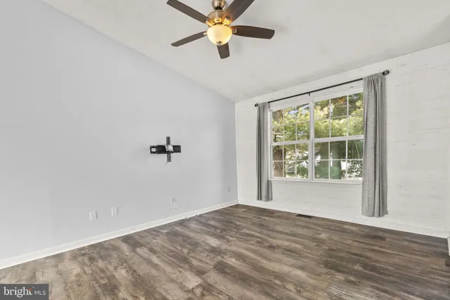 wooden floor in an empty room with a window