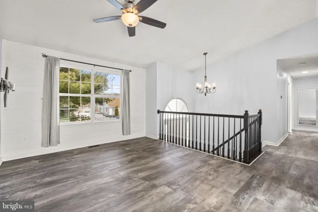 a view of a room with wooden floor and windows