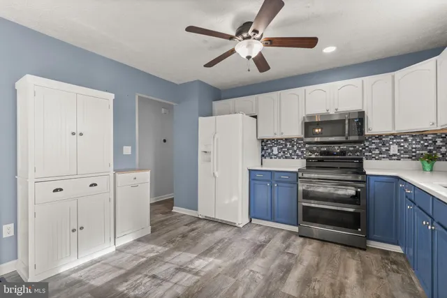 a kitchen with stainless steel appliances a stove cabinets and refrigerator