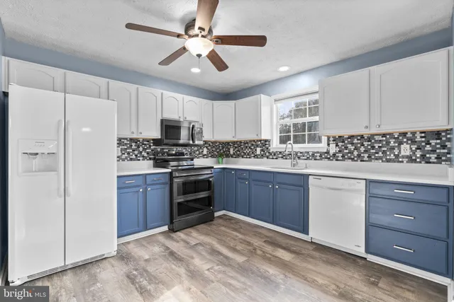 a kitchen with a refrigerator stove and sink