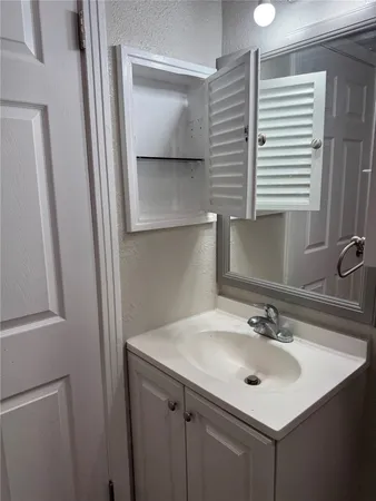a bathroom with a sink and a mirror