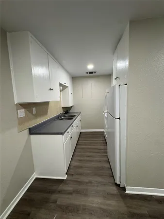 a kitchen with stainless steel appliances granite countertop a refrigerator a sink and a stove