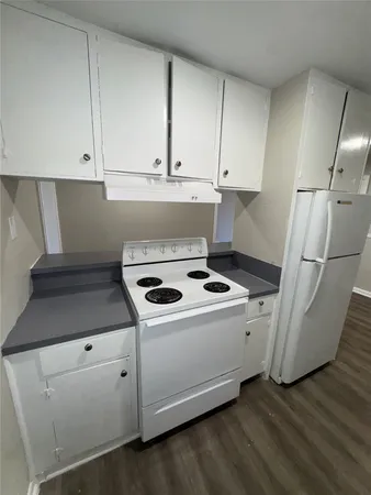 a kitchen with a stove and a refrigerator