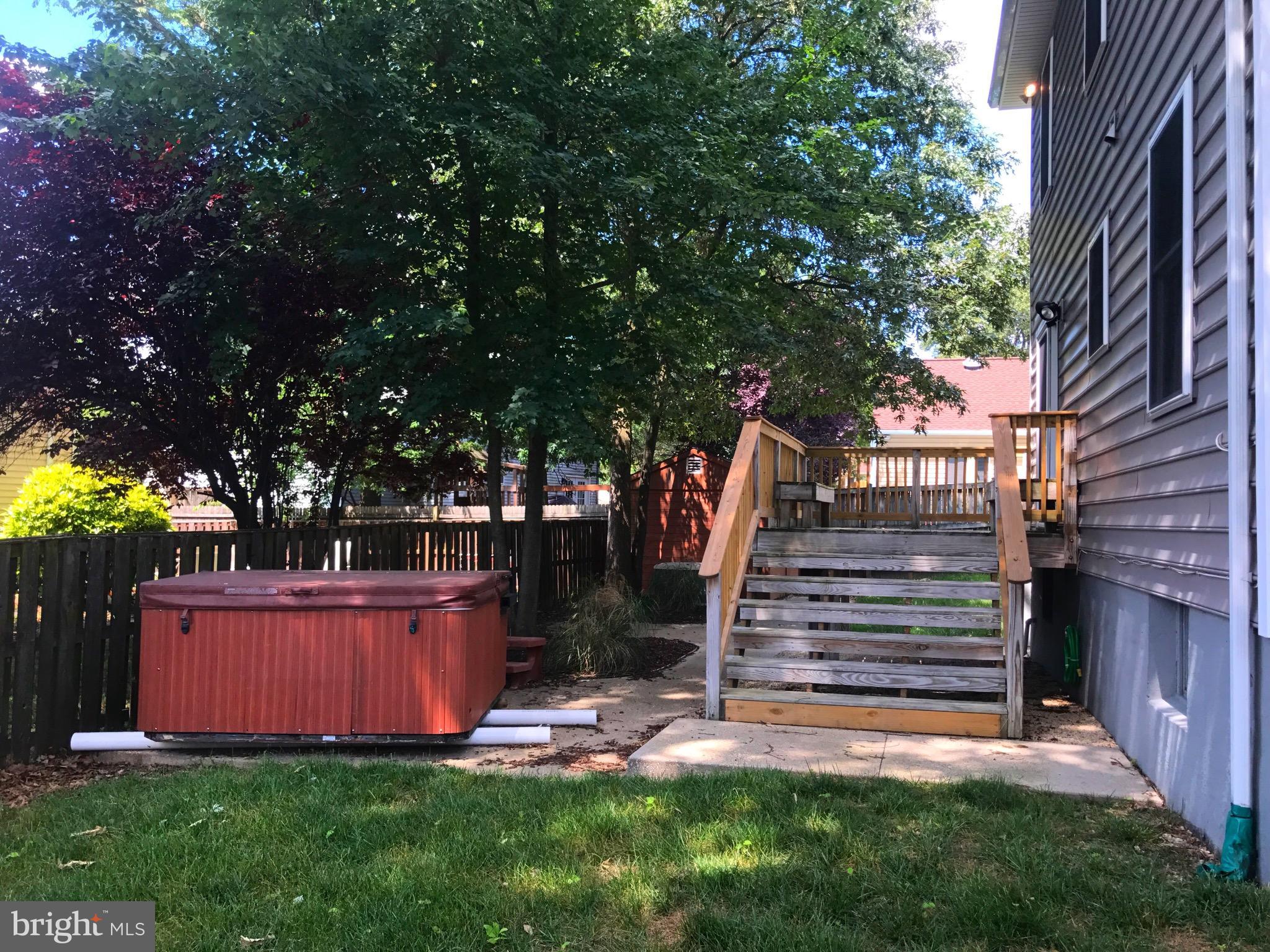 2897 Dungate Road Pasadena, MD 21122 - Photo 5 of 30 a view of backyard with wooden fence and a large tree