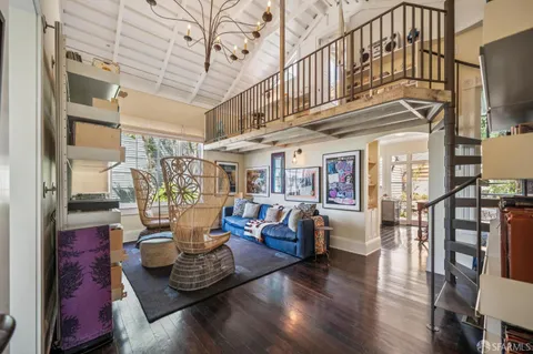 a living room with furniture fireplace and wooden floor