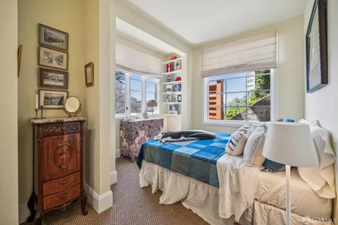 a bedroom with bed and a window