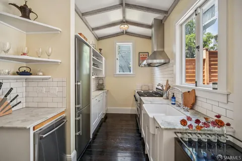 a kitchen with stainless steel appliances granite countertop a stove and a sink
