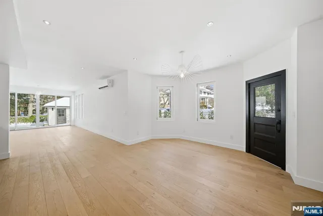 a large white kitchen with a large window