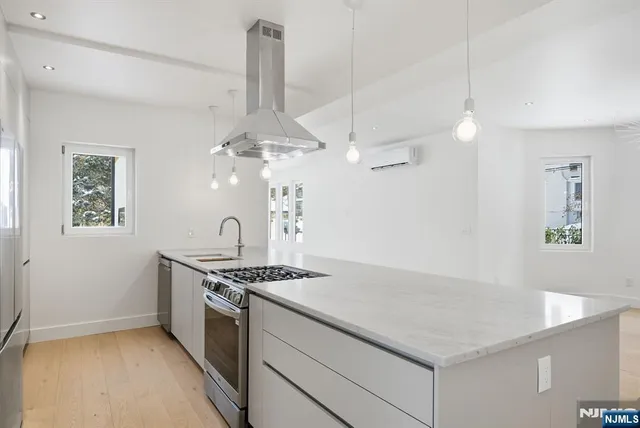 a kitchen with granite countertop a sink stainless steel appliances and cabinets