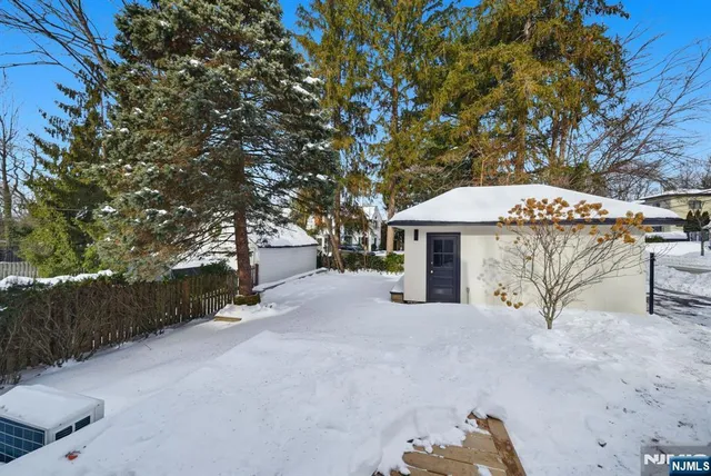 an aerial view of a house with a yard and large trees
