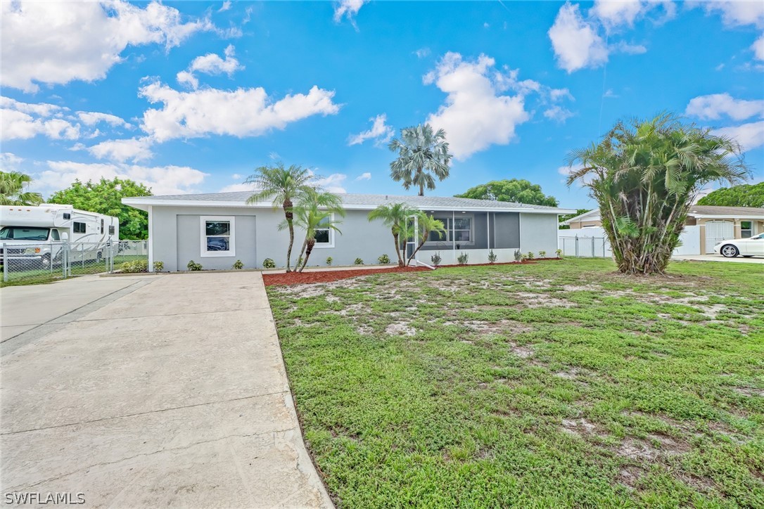 112 Rowland Road Lehigh Acres, FL 33936 - Photo 1 of 22 a view of a house with a yard