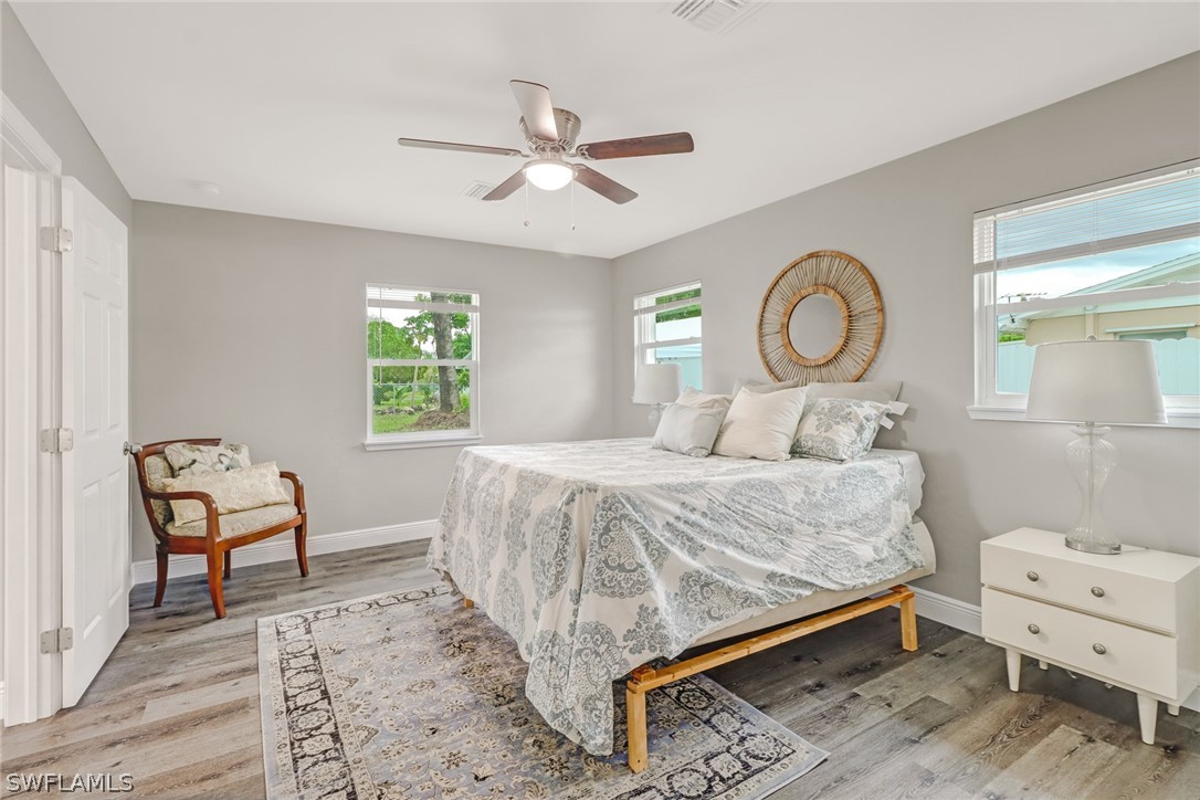 112 Rowland Road Lehigh Acres, FL 33936 - Photo 11 of 22 a bedroom with a bed and a chandelier