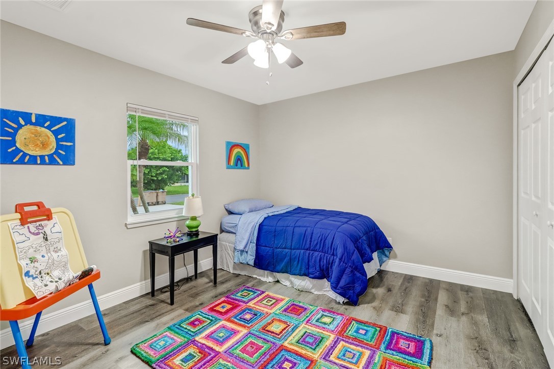 112 Rowland Road Lehigh Acres, FL 33936 - Photo 14 of 22 a bedroom with a bed and a window