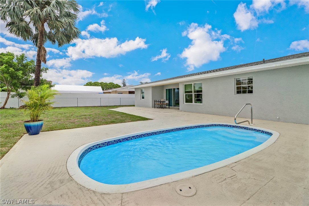 112 Rowland Road Lehigh Acres, FL 33936 - Photo 20 of 22 a swimming pool with outdoor seating and yard