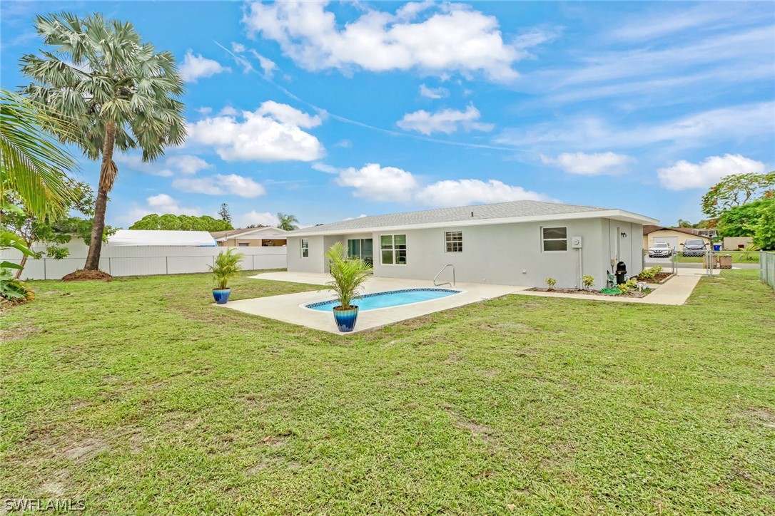 112 Rowland Road Lehigh Acres, FL 33936 - Photo 22 of 22 a view of a house with a backyard
