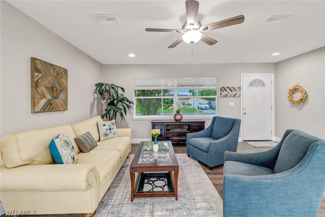 112 Rowland Road Lehigh Acres, FL 33936 - Photo 3 of 22 a living room with furniture potted plant and a window