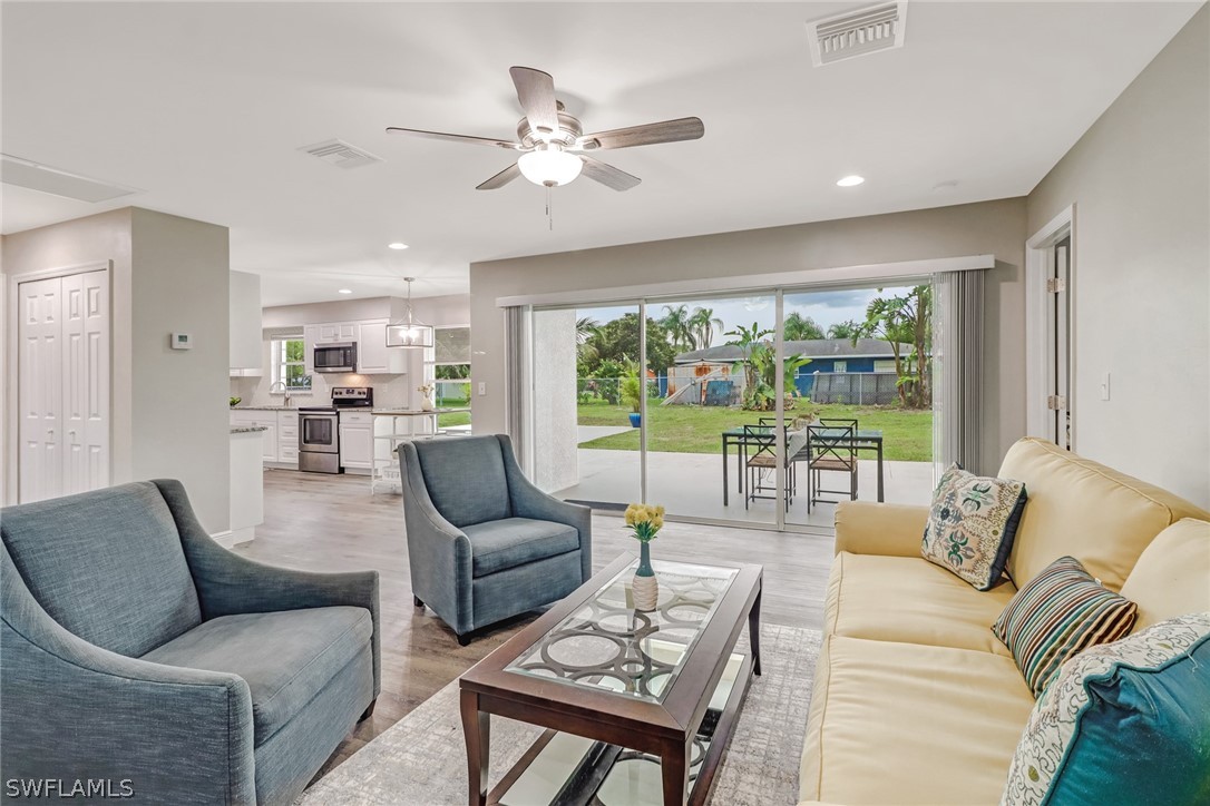 112 Rowland Road Lehigh Acres, FL 33936 - Photo 5 of 22 a living room with furniture and a large window