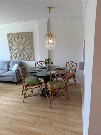 an empty room with wooden floor and glass door