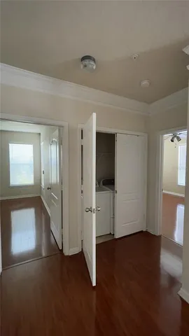 a view of empty room with wooden floor and window