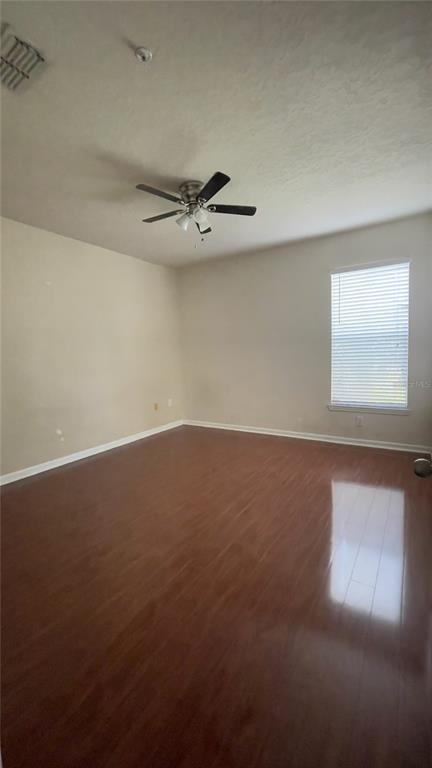 8849 Villa View Circle, Unit 206 Orlando, FL 32821 - Photo 12 of 19 en empty room with windows and ceiling fan