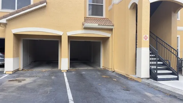 a view of a hallway with wooden cabinets and entryway