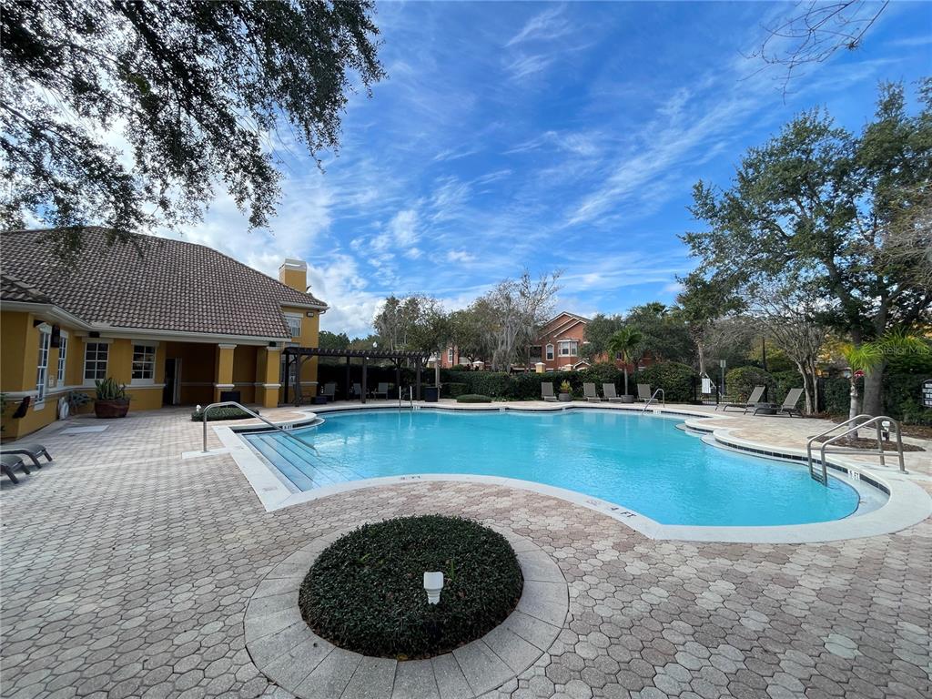 8849 Villa View Circle, Unit 206 Orlando, FL 32821 - Photo 18 of 19 a view of a swimming pool with lounge chair