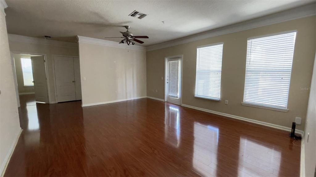 8849 Villa View Circle, Unit 206 Orlando, FL 32821 - Photo 3 of 19 a view of an empty room with wooden floor and a window