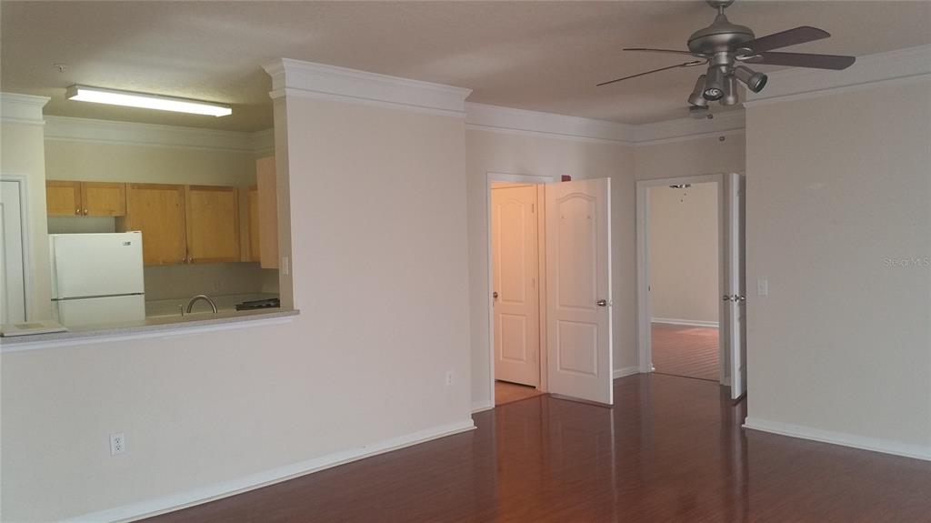 8849 Villa View Circle, Unit 206 Orlando, FL 32821 - Photo 5 of 19 a view of a room with a chandelier fan and wooden floor