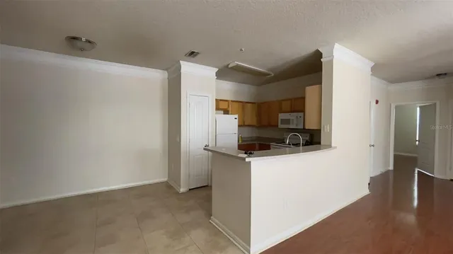 a kitchen with stainless steel appliances a refrigerator and a stove top oven