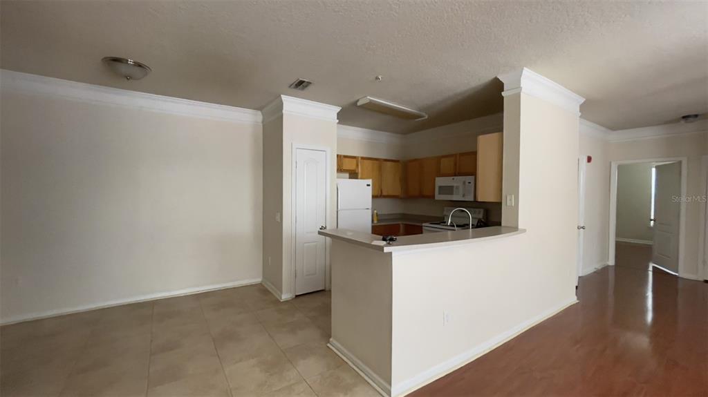 8849 Villa View Circle, Unit 206 Orlando, FL 32821 - Photo 7 of 19 a kitchen with stainless steel appliances a refrigerator and a stove top oven