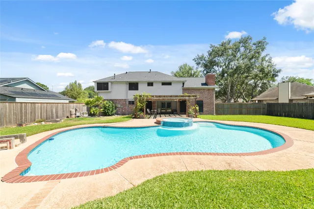 a view of empty room with wooden floor and fireplace