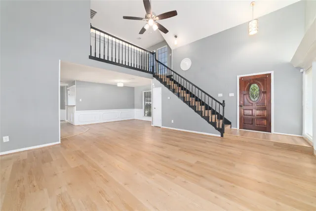 a kitchen with granite countertop white cabinets and stainless steel appliances