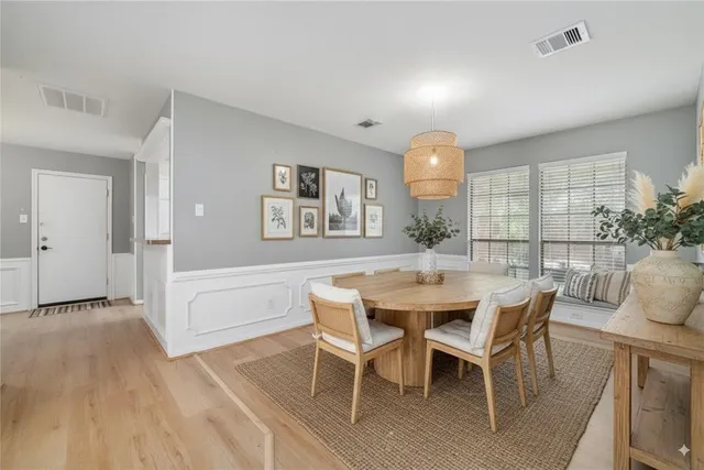 a view of an empty room with a window and a ceiling fan