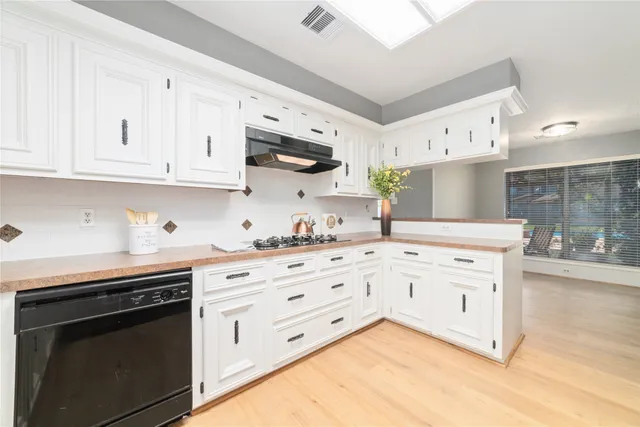 a bathroom with a granite countertop sink a large mirror and a bathtub with view of mirror