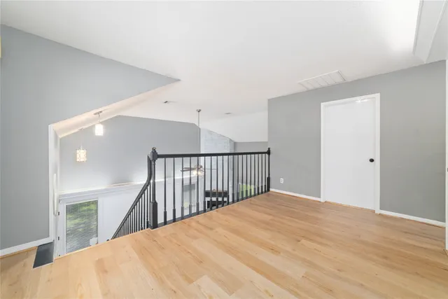 an aerial view of a house with a yard and lake