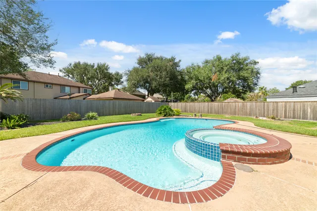 a view of a house with swimming pool and a yard
