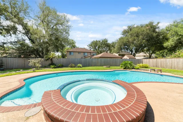a living room with patio furniture and a potted plant
