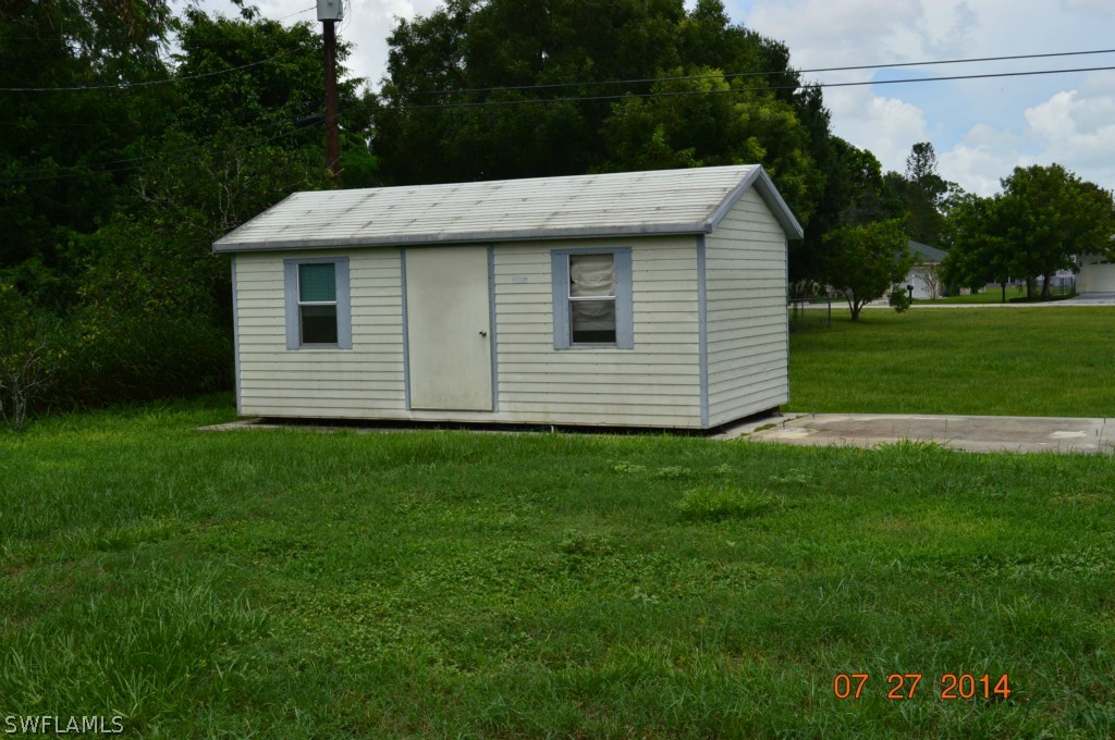 14 Kentucky Road Lehigh Acres, FL 33936 - Photo 4 of 11 a view of a white house with a yard