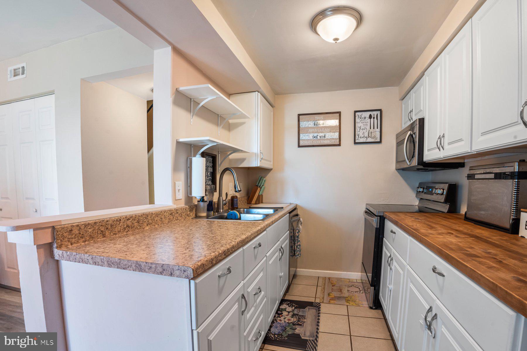 120 Danford Drive Elkton, MD 21921 - Photo 9 of 25 a kitchen with granite countertop a sink stove and cabinets
