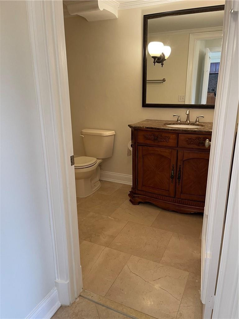 491 Racquet Club Road, Unit 109 Weston, FL 33326 - Photo 21 of 39 a bathroom with a toilet and vanity
