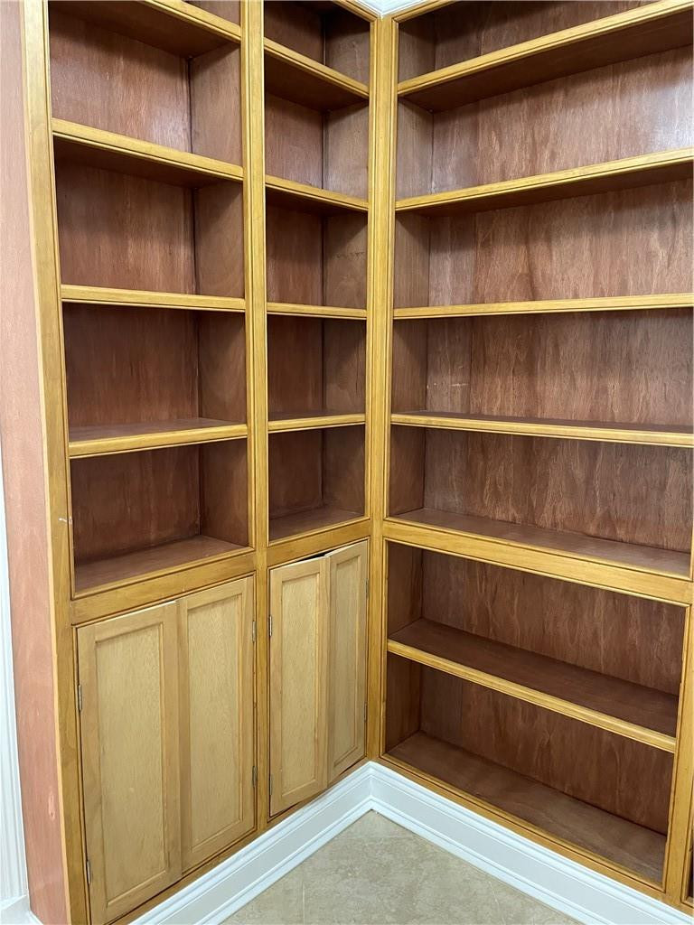 491 Racquet Club Road, Unit 109 Weston, FL 33326 - Photo 25 of 39 a view of walk in closet with empty racks