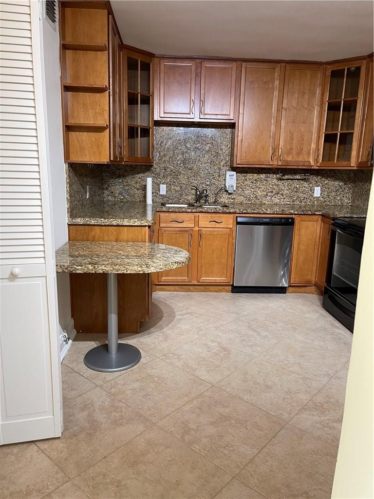491 Racquet Club Road, Unit 109 Weston, FL 33326 - Photo 30 of 39 a kitchen with stainless steel appliances granite countertop a stove a sink and a microwave