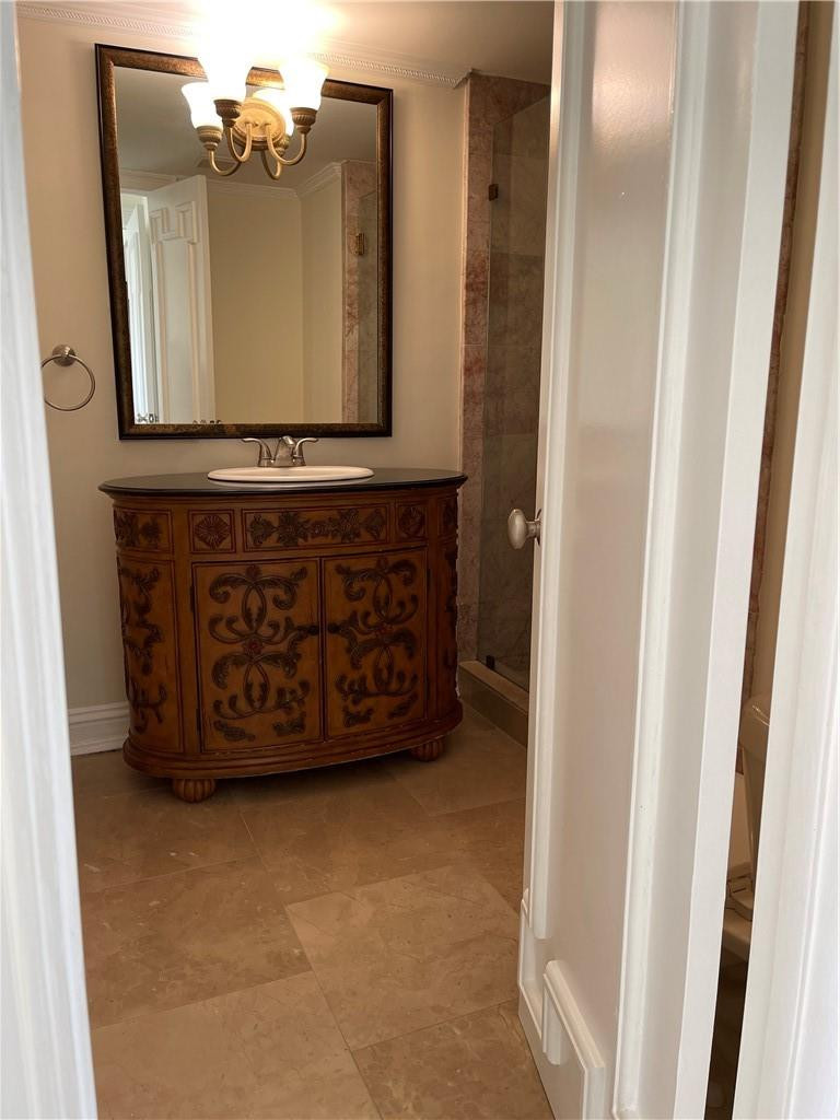 491 Racquet Club Road, Unit 109 Weston, FL 33326 - Photo 35 of 39 a bathroom with a mirror and a sink