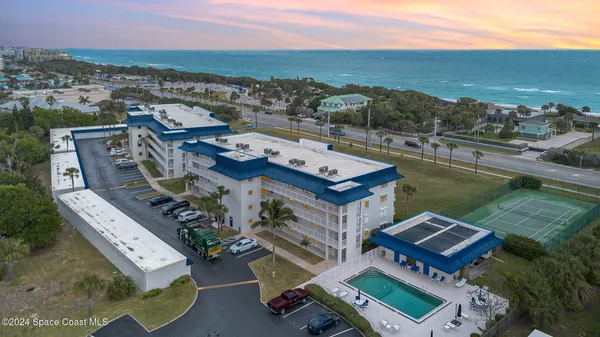 an aerial view of a house with a ocean view