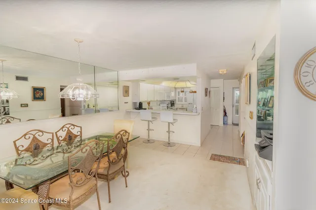 a large white kitchen with a large window