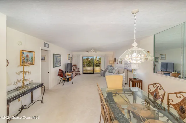 a living room with furniture chandelier and a chandelier