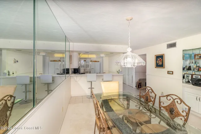 a large kitchen with a large window and chandelier